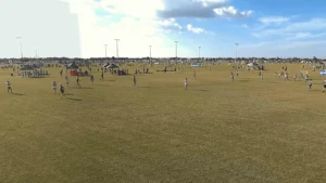 Wide auto-cam view of a whole lacrosse field; the players are tiny